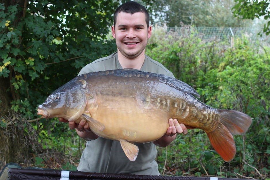 John Webster holding a big Carp fish.